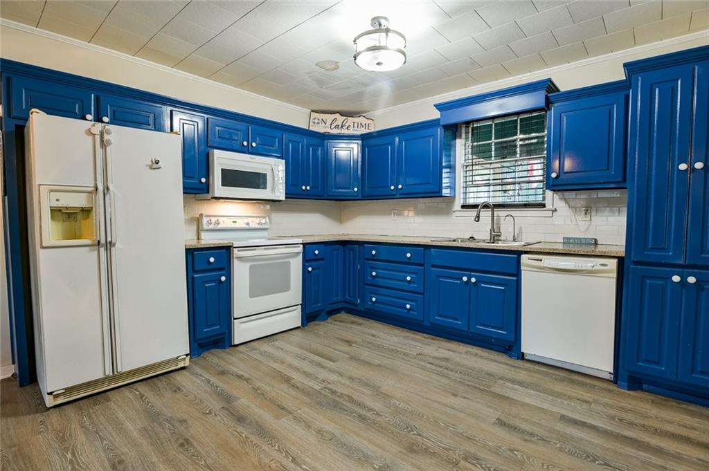 458 Haley Road Jackson, GA 30233 - Photo 13 of 58 a kitchen with stainless steel appliances granite countertop a refrigerator a sink dishwasher a stove with wooden cabinets and floor