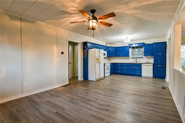 a view of a hallway with wooden floor and entryway