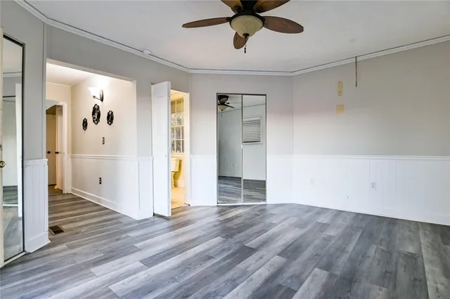 a view of a lake from a balcony with furniture