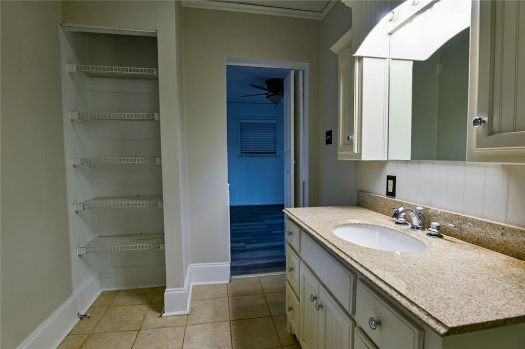 458 Haley Road Jackson, GA 30233 - Photo 28 of 58 a bathroom with a granite countertop sink and a mirror