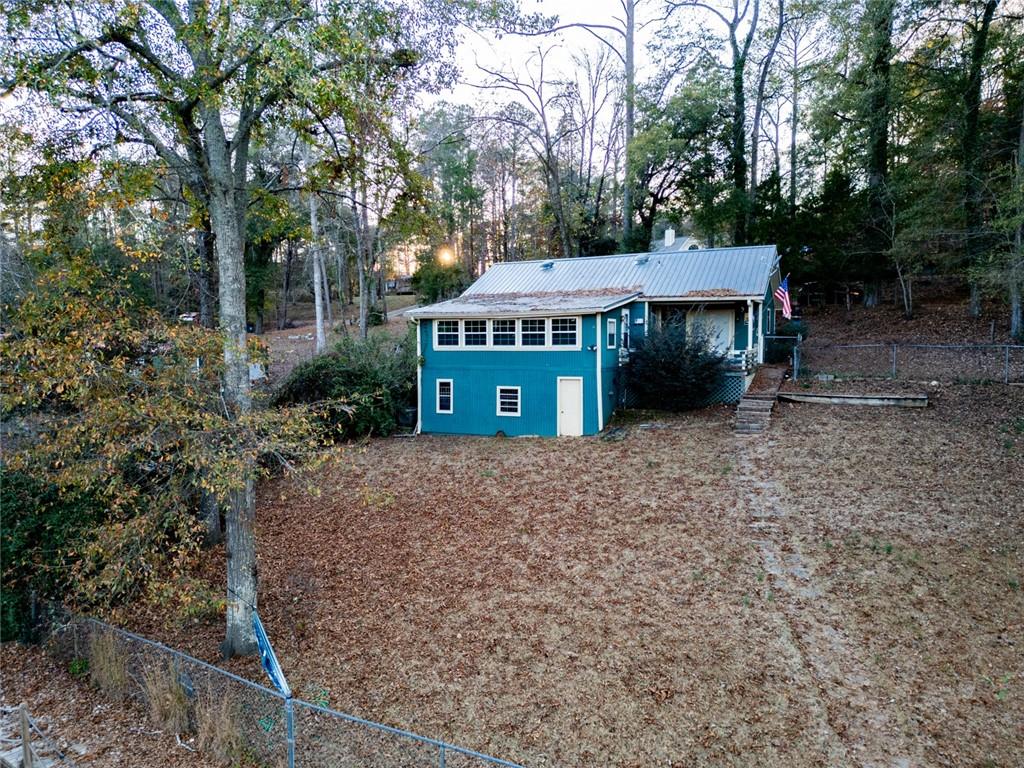 458 Haley Road Jackson, GA 30233 - Photo 5 of 58 a view of a big house with large trees and a small barn