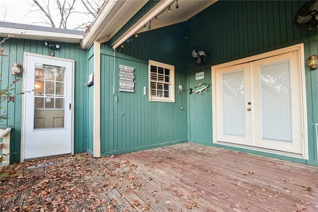 a view of a big room with wooden floor and windows