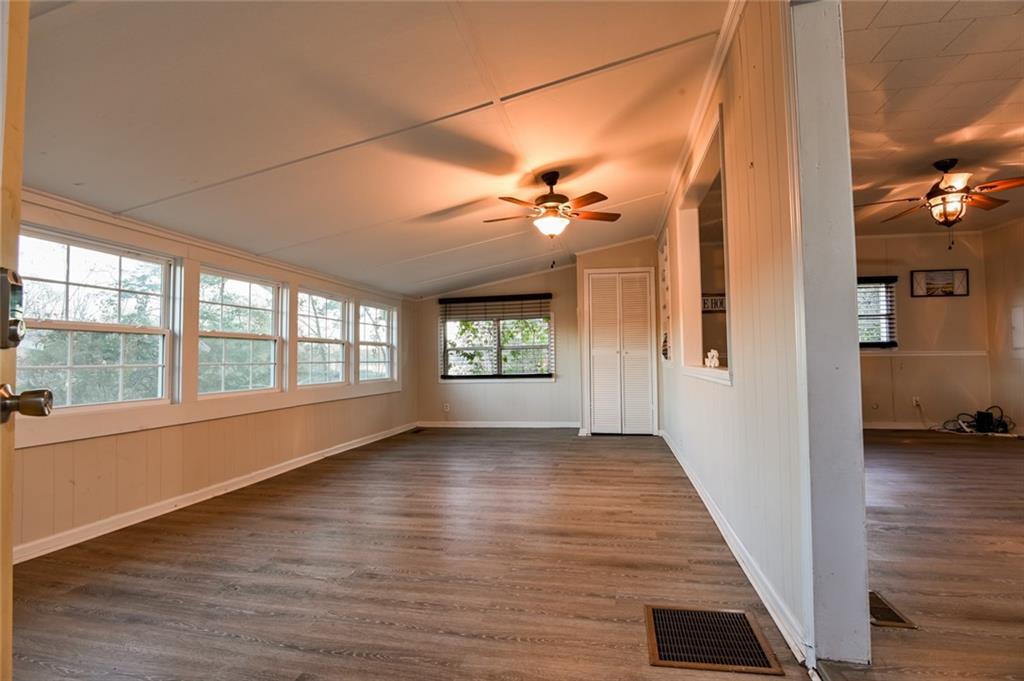 458 Haley Road Jackson, GA 30233 - Photo 7 of 58 a view of an empty room with a window and wooden floor