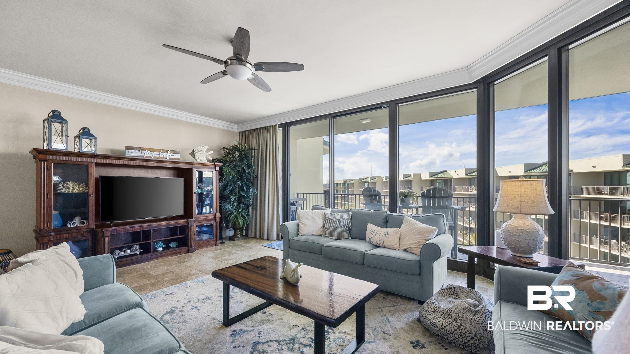 27580 Canal Road, Unit 1526 Orange Beach, AL 36561 - Photo 7 of 49 Living area featuring a wall of windows, crown molding, and ceiling fan