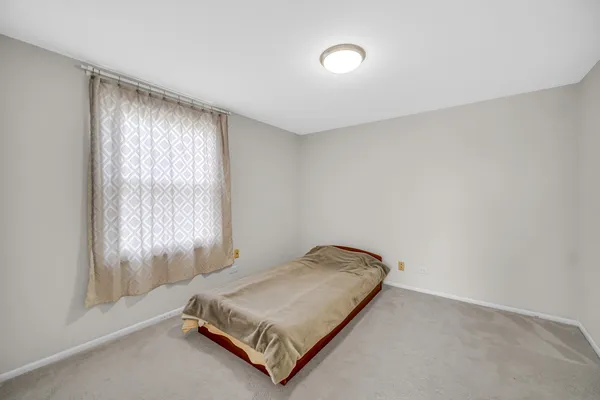 a room with a bed and a window