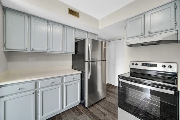 a kitchen with cabinets and stainless steel appliances