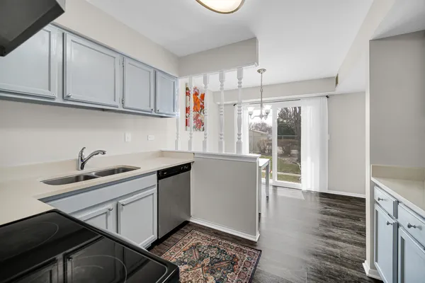 a kitchen with stainless steel appliances granite countertop a sink stove and cabinets