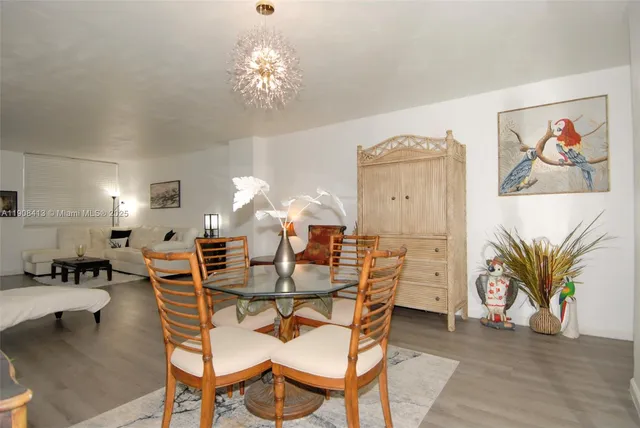 a view of a dining room with furniture and chandelier