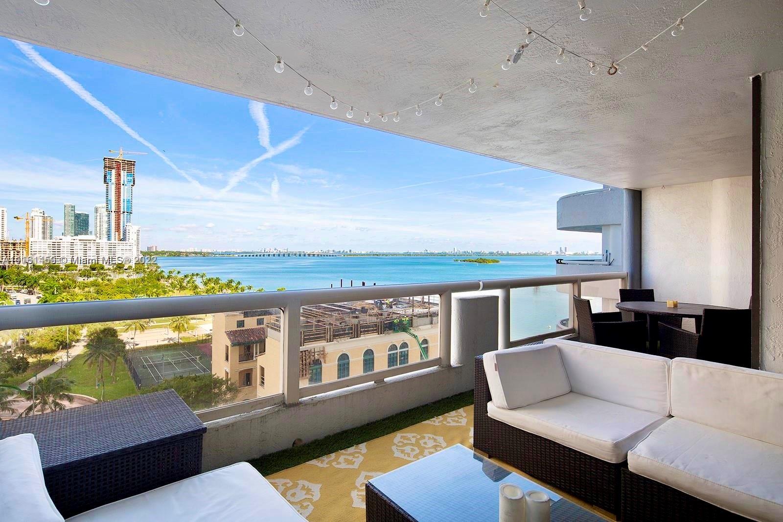 1717 North Bayshore Drive, Unit A1239 Miami, FL 33132 - Photo 2 of 16 a living room with furniture wooden floor and a large window