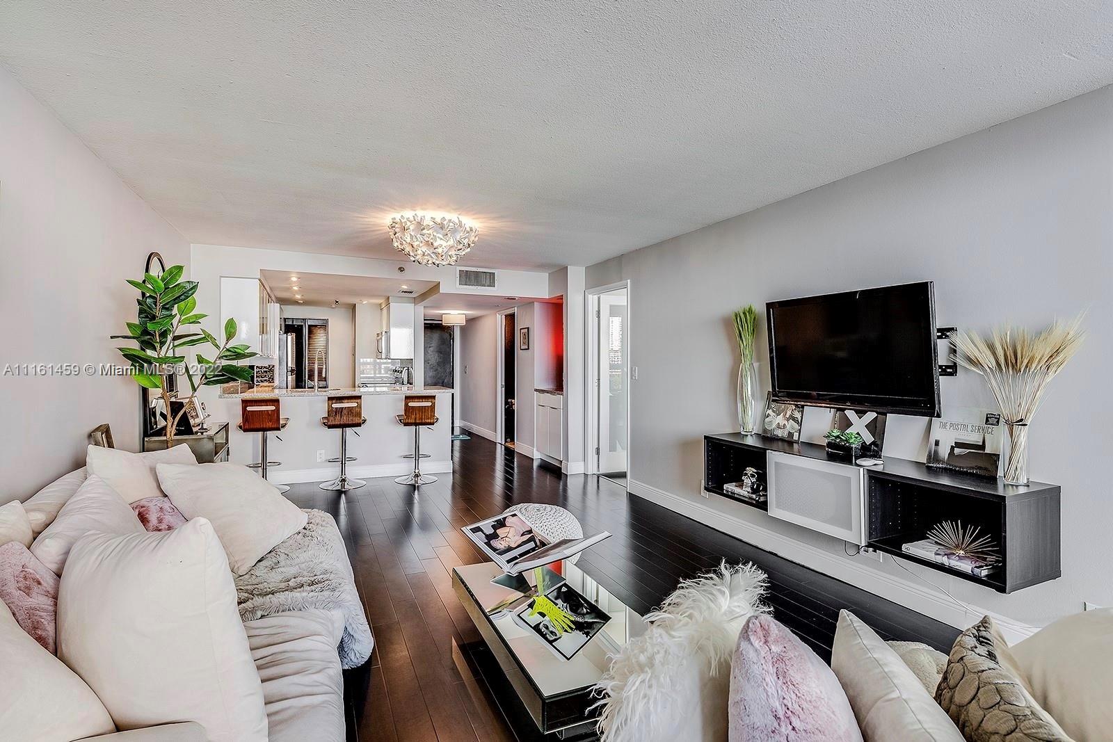 1717 North Bayshore Drive, Unit A1239 Miami, FL 33132 - Photo 3 of 16 a living room with furniture and a flat screen tv