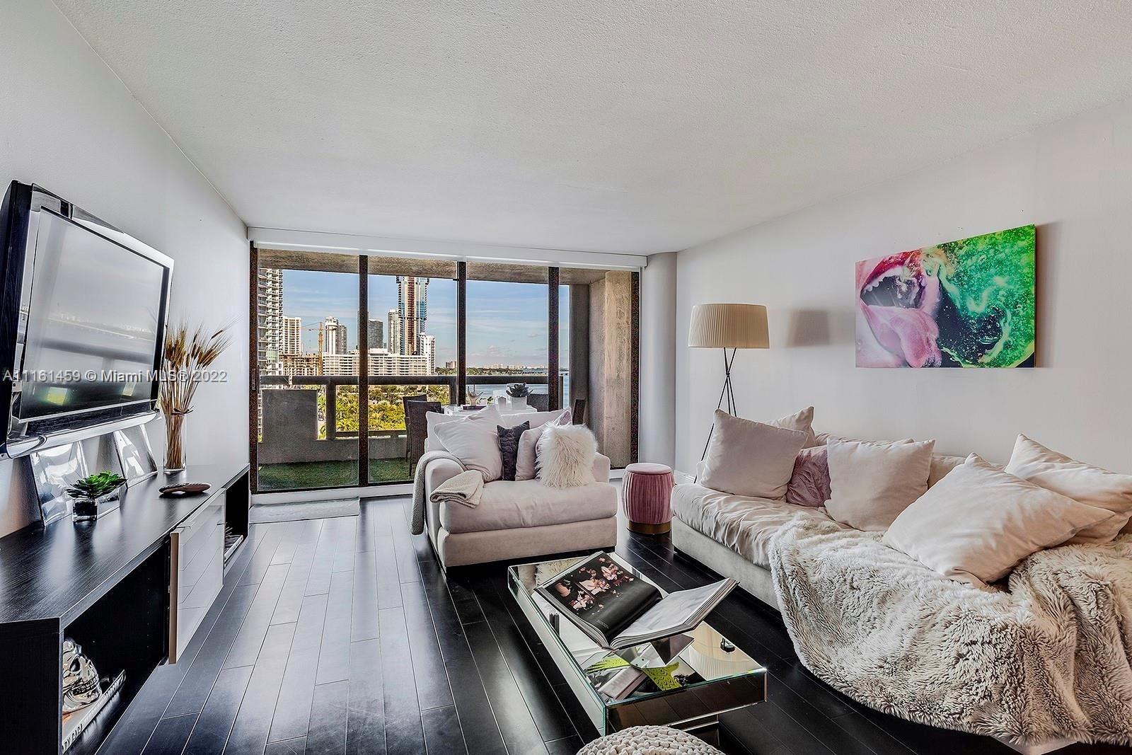 1717 North Bayshore Drive, Unit A1239 Miami, FL 33132 - Photo 4 of 16 a living room with furniture and a flat screen tv