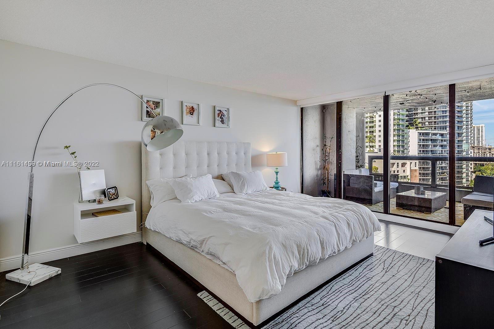 1717 North Bayshore Drive, Unit A1239 Miami, FL 33132 - Photo 7 of 16 a bedroom with a large bed and a window