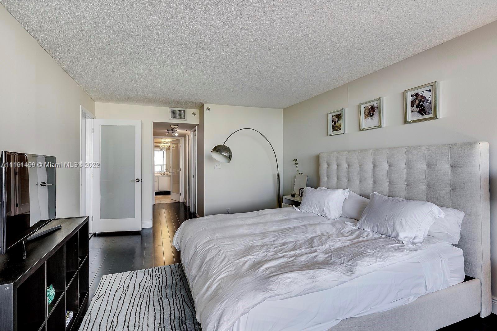 1717 North Bayshore Drive, Unit A1239 Miami, FL 33132 - Photo 8 of 16 a bedroom with a bed and a flat screen tv