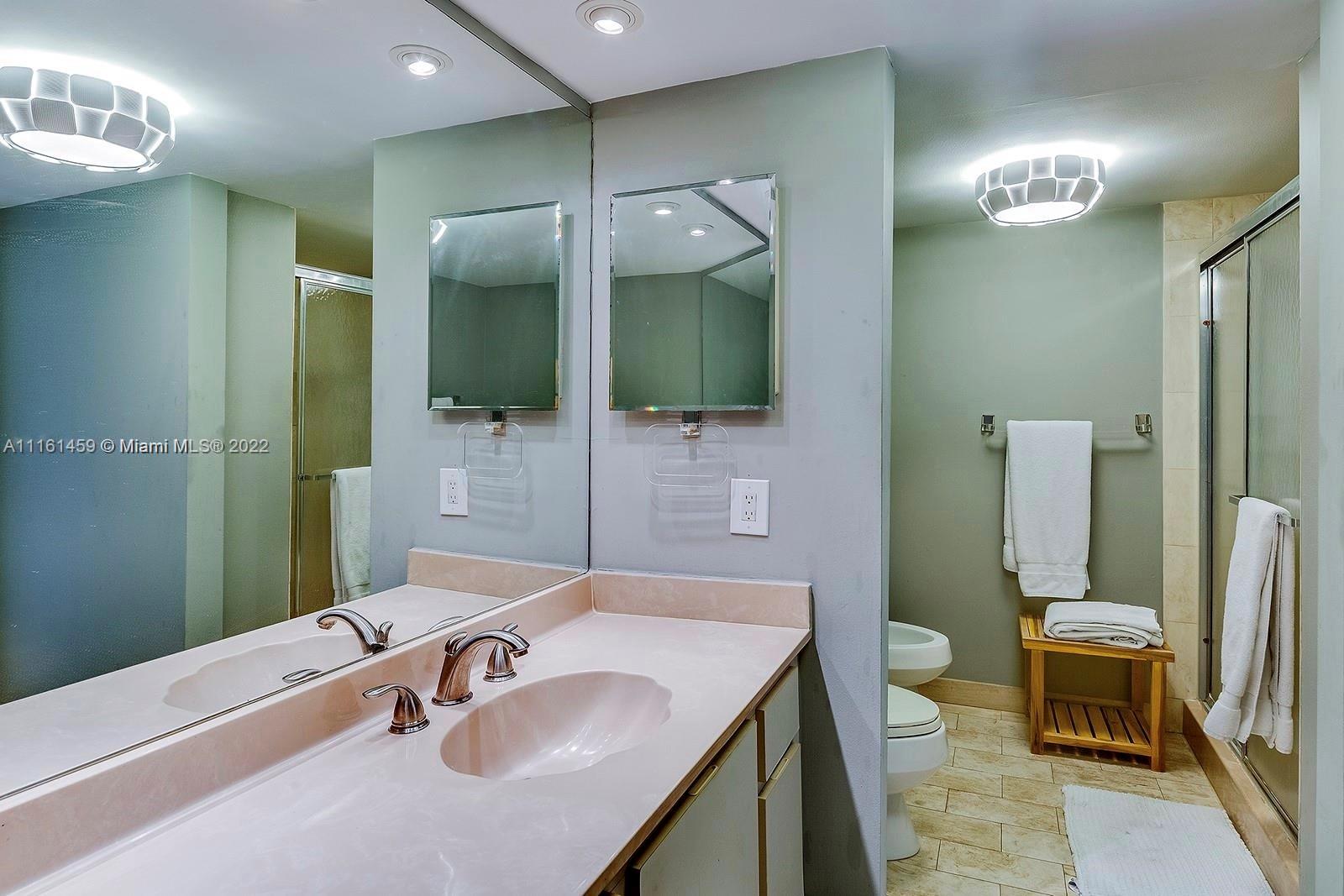 1717 North Bayshore Drive, Unit A1239 Miami, FL 33132 - Photo 10 of 16 a bathroom with a sink a toilet and a mirror