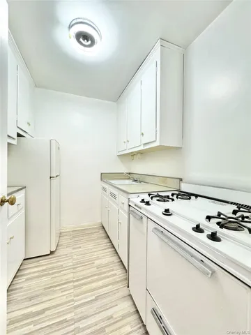 a kitchen with a stove and a white refrigerator
