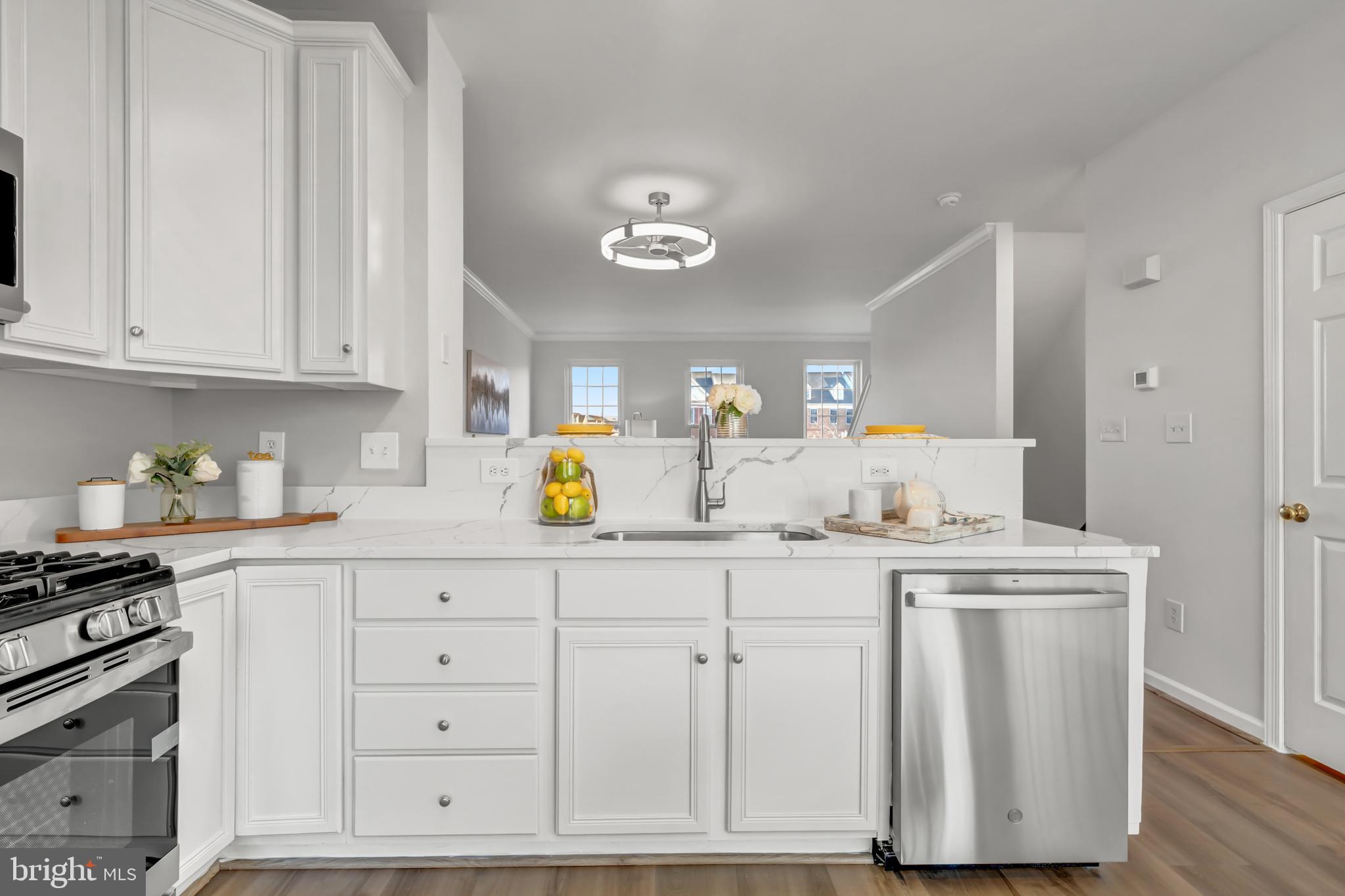 42790 Nations Street Chantilly, VA 20152 - Photo 18 of 40 a kitchen with white cabinets and sink