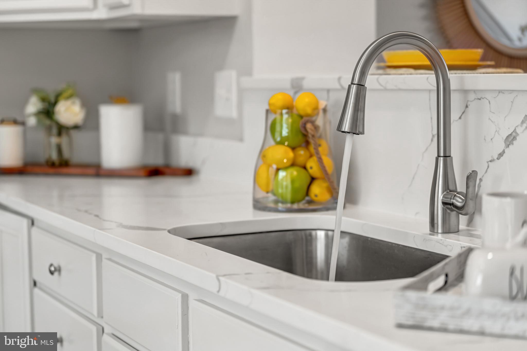 42790 Nations Street Chantilly, VA 20152 - Photo 21 of 40 a kitchen with a sink a counter and a lamp