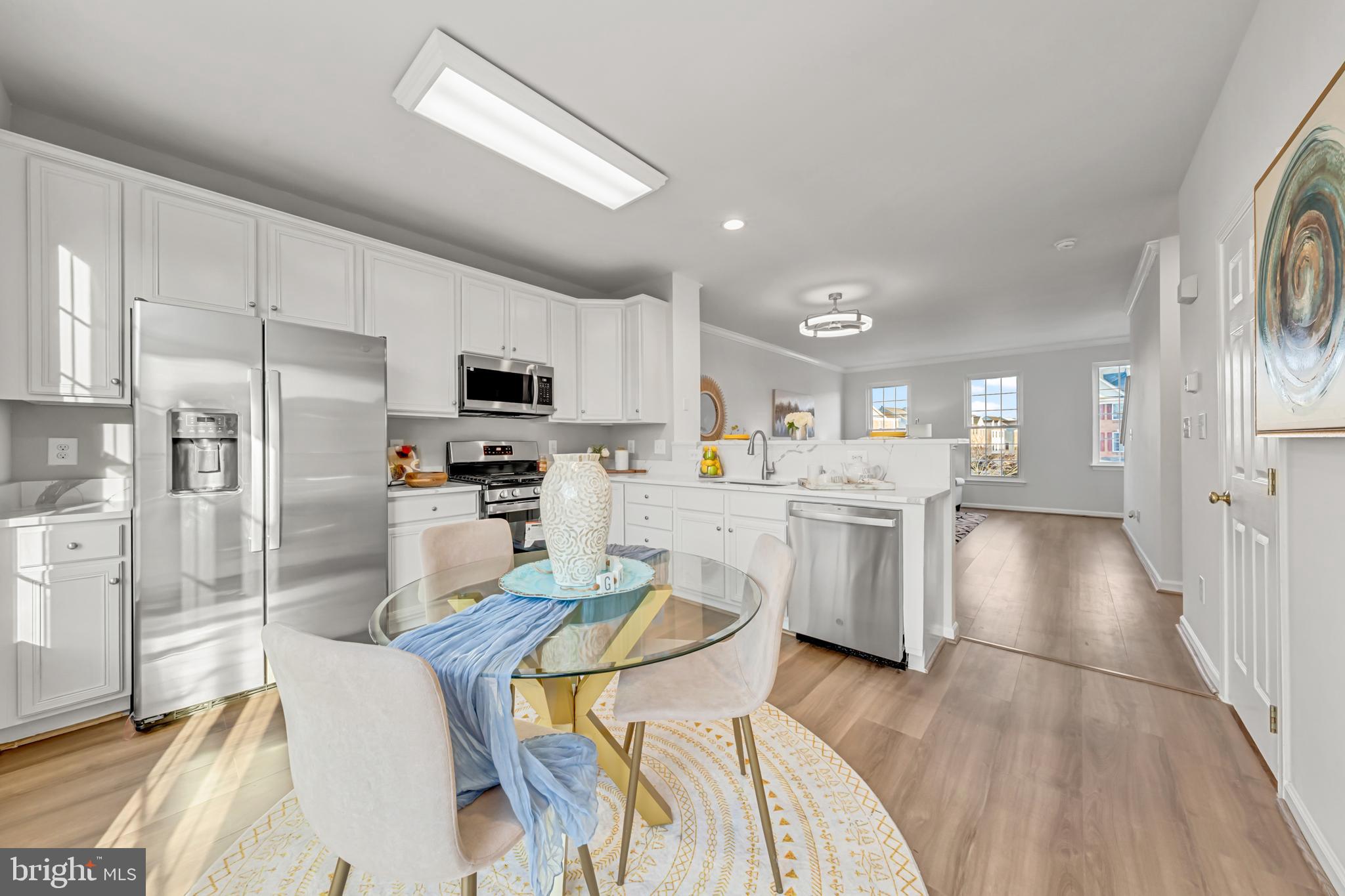 42790 Nations Street Chantilly, VA 20152 - Photo 23 of 40 a kitchen with white cabinets and stainless steel appliances