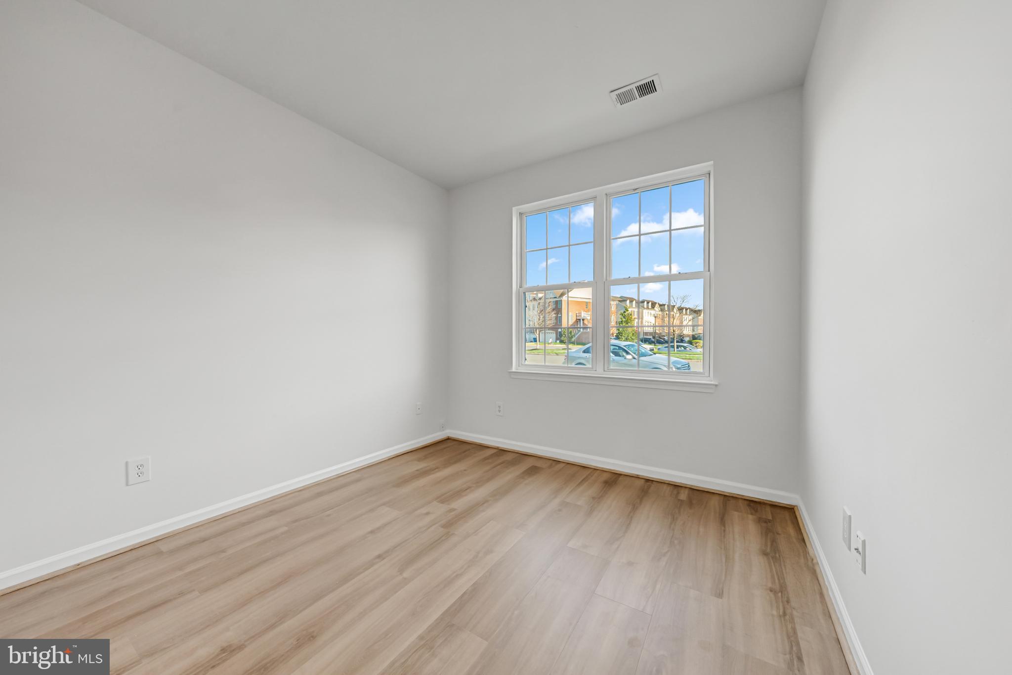 42790 Nations Street Chantilly, VA 20152 - Photo 27 of 40 a view of an empty room with wooden floor and a window