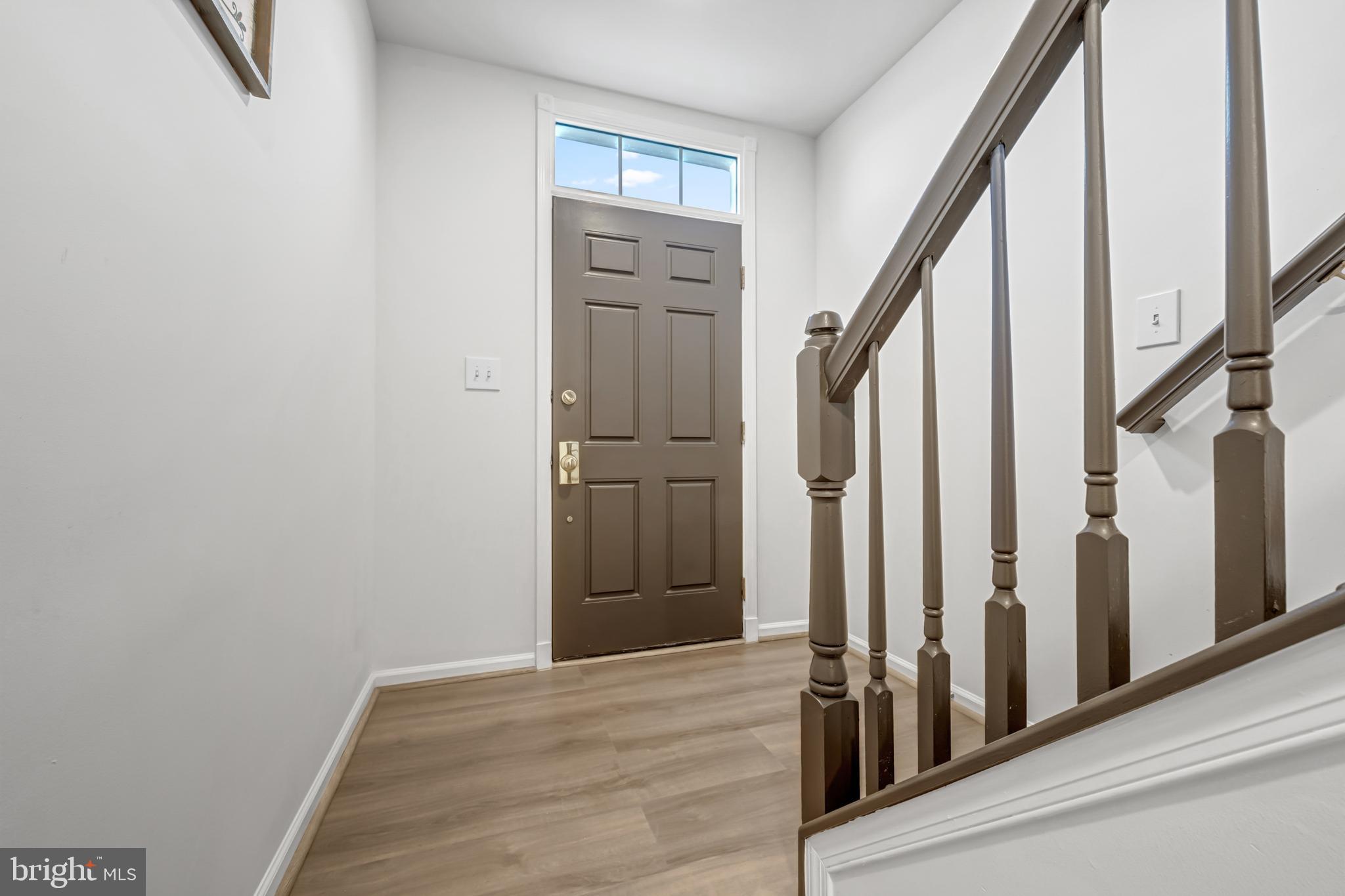 42790 Nations Street Chantilly, VA 20152 - Photo 9 of 40 a view of a hallway with wooden floor and staircase