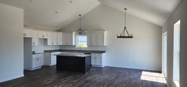 a kitchen with kitchen island a counter space a sink and appliances