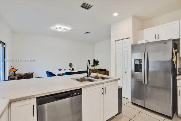 a kitchen with stainless steel appliances a refrigerator sink and cabinets