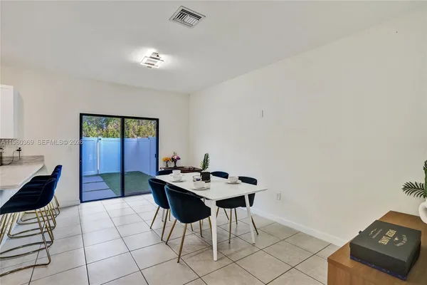 a dining room with furniture and window