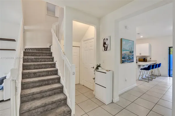 a view of entryway and hall with dining room