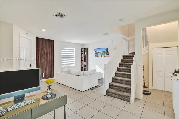 a living room with furniture and a flat screen tv