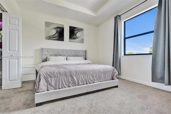 a bathroom with a sink vanity granite tub and a mirror