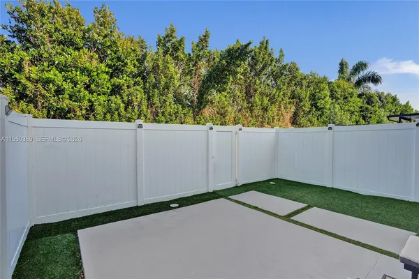 a view of swimming pool that has lawn chairs wooden floor and lake view