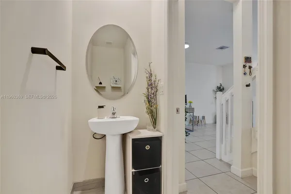 a bathroom with a sink a mirror and shower