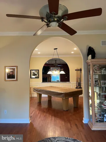 a living room with table chairs and a potted plant
