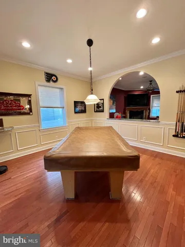 a room with pool table and windows