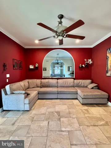 a living room with furniture and a pool table