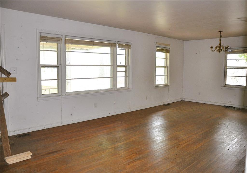 590 Villa Rica Highway Dallas, GA 30157 - Photo 13 of 17 an empty room with wooden floor and windows