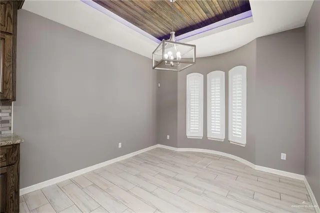 a view of a room with wooden floor and chandelier