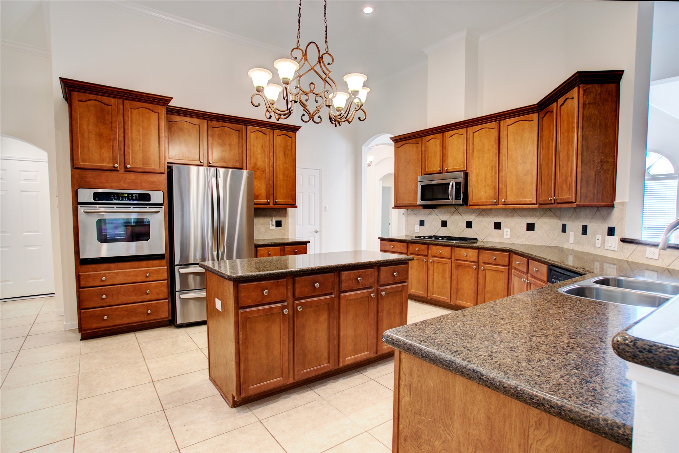 3327 River Bend Drive Rosenberg, TX 77471 - Photo 11 of 33 a kitchen with stainless steel appliances granite countertop a sink dishwasher stove and refrigerator
