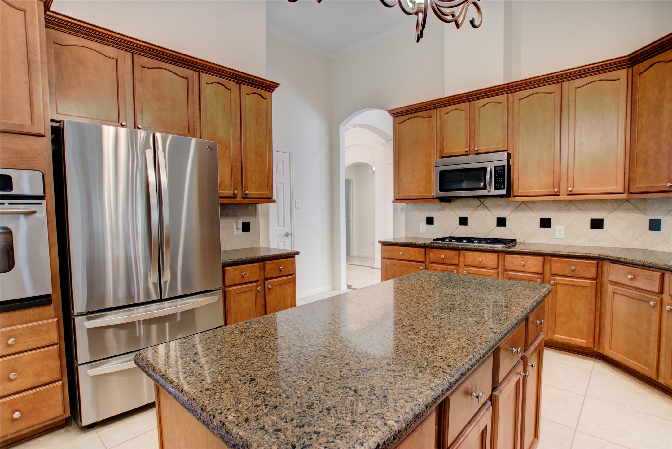 3327 River Bend Drive Rosenberg, TX 77471 - Photo 12 of 33 a kitchen with stainless steel appliances granite countertop a refrigerator a stove top oven and sink