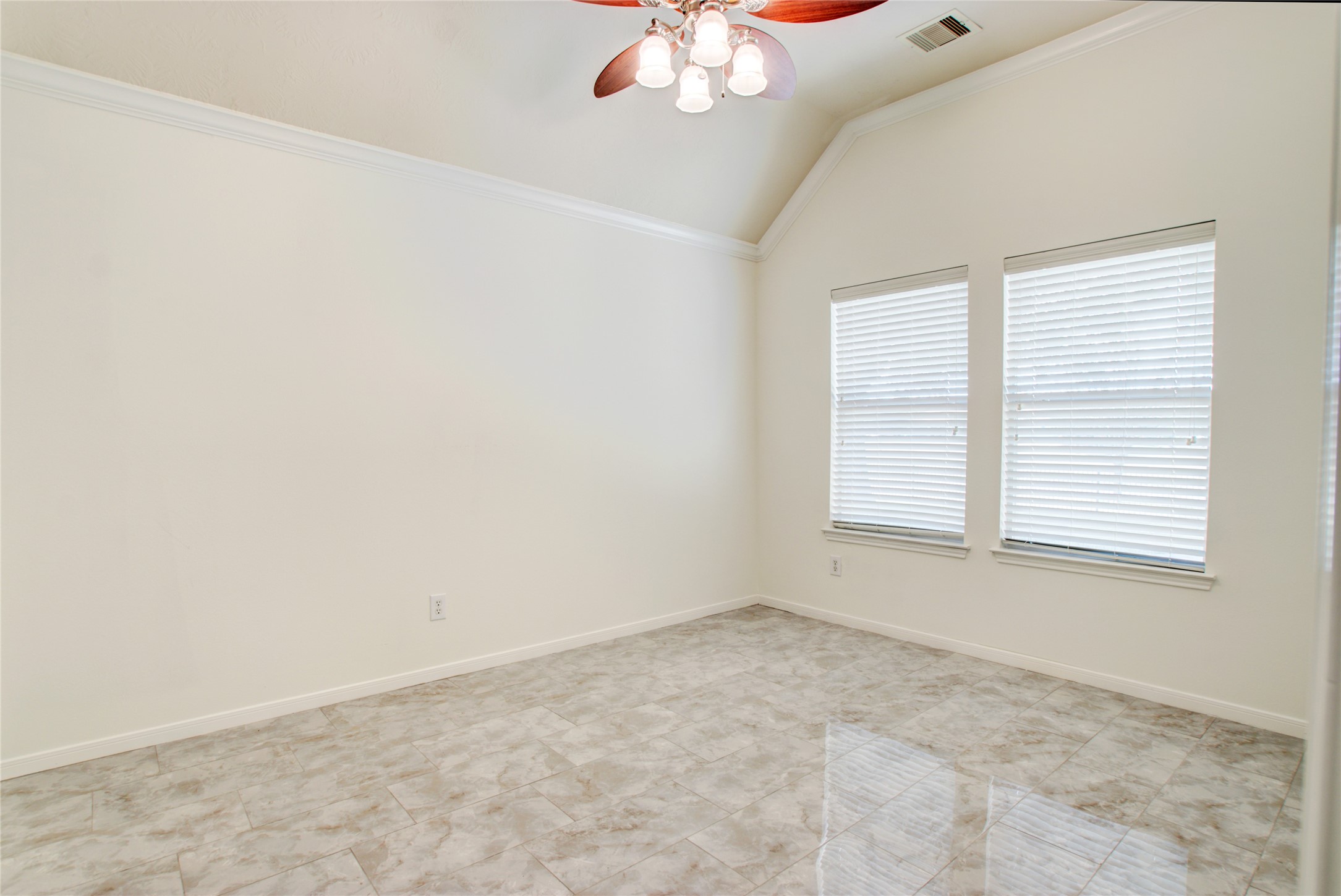3327 River Bend Drive Rosenberg, TX 77471 - Photo 21 of 33 an empty room with a chandelier fan and windows