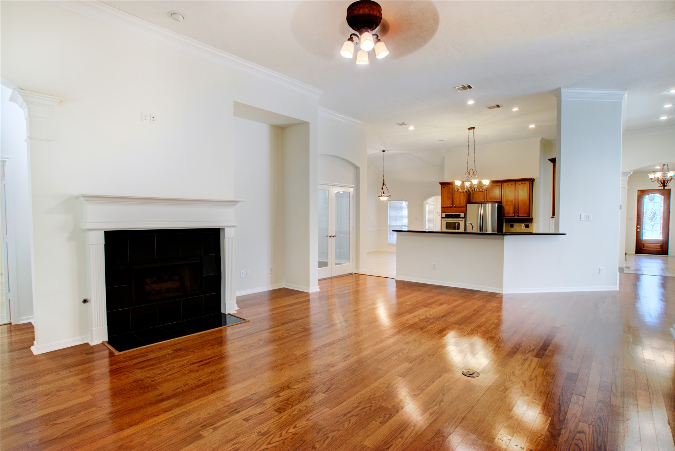 3327 River Bend Drive Rosenberg, TX 77471 - Photo 8 of 33 a view of an empty room with wooden floor and a fireplace