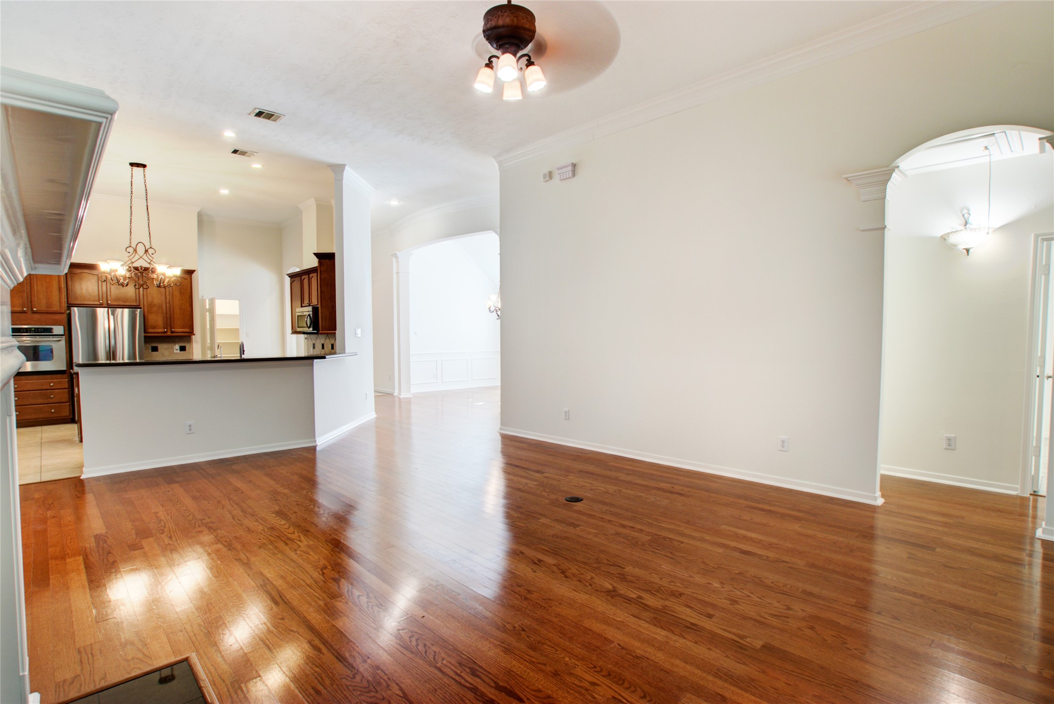 3327 River Bend Drive Rosenberg, TX 77471 - Photo 9 of 33 a view of a kitchen with wooden floor and a hallway