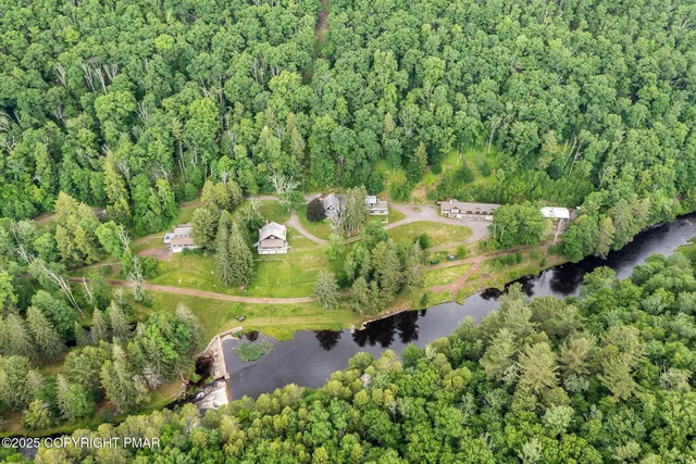 an aerial view of a house with a yard