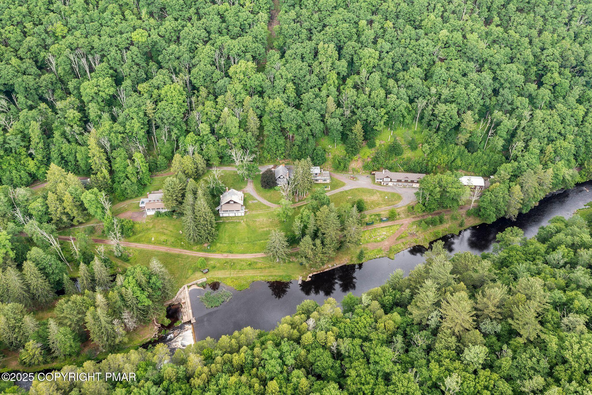 an aerial view of a house with a yard