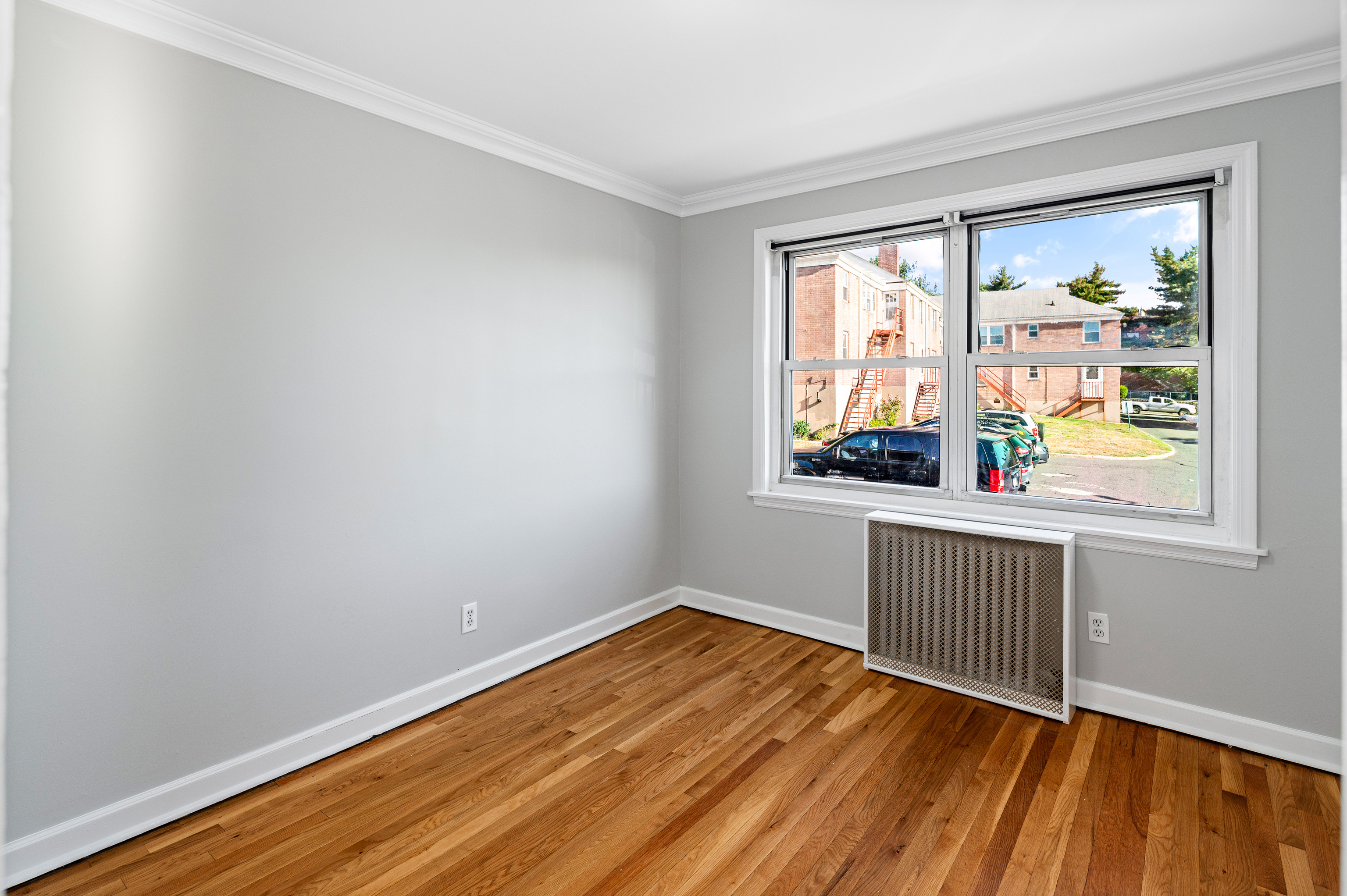 23 Standish Road, Unit 2 Stamford, CT 06902 - Photo 16 of 27 an empty room with wooden floor and windows