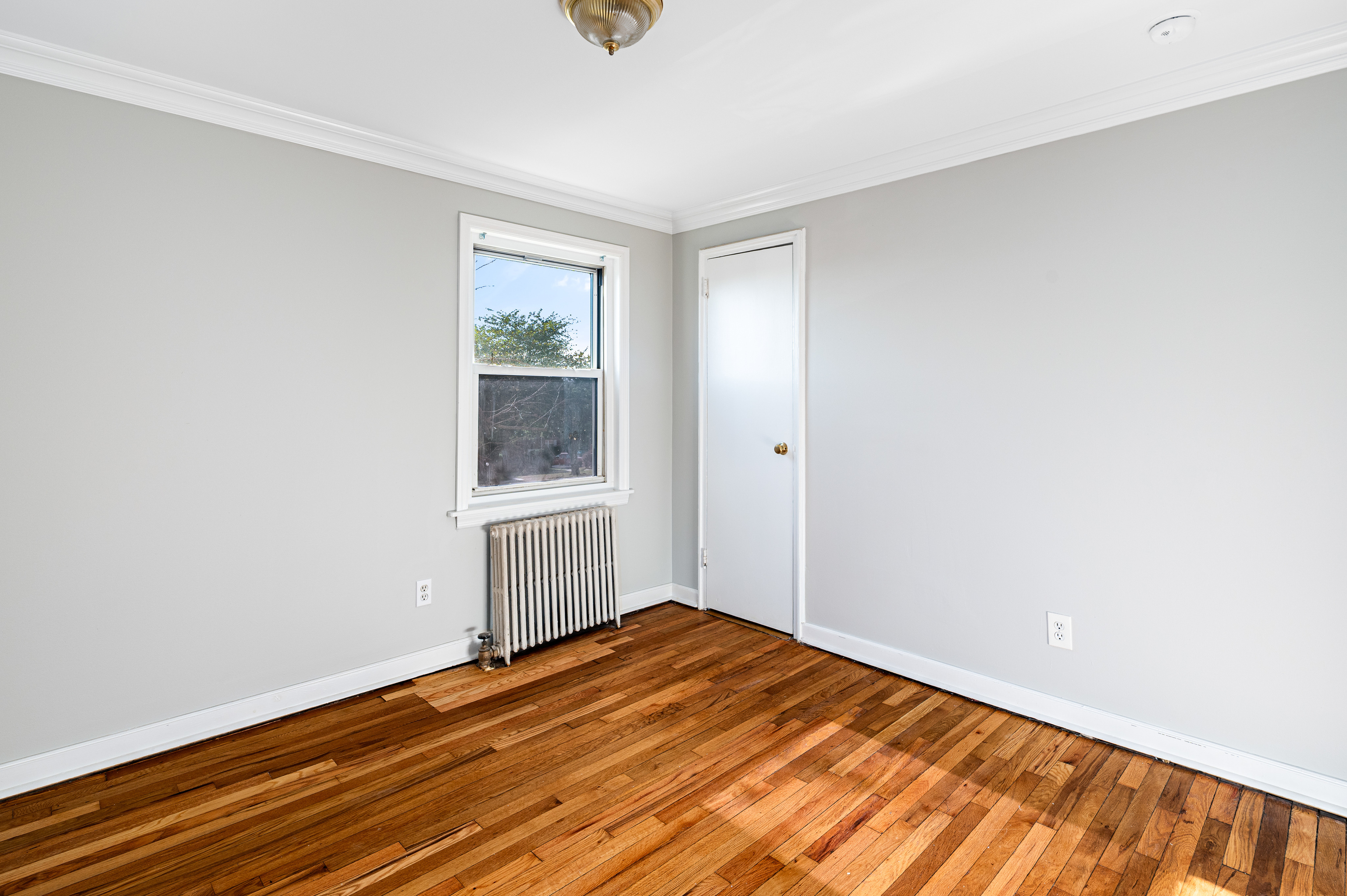 23 Standish Road, Unit 2 Stamford, CT 06902 - Photo 17 of 27 a view of an empty room with wooden floor and a window
