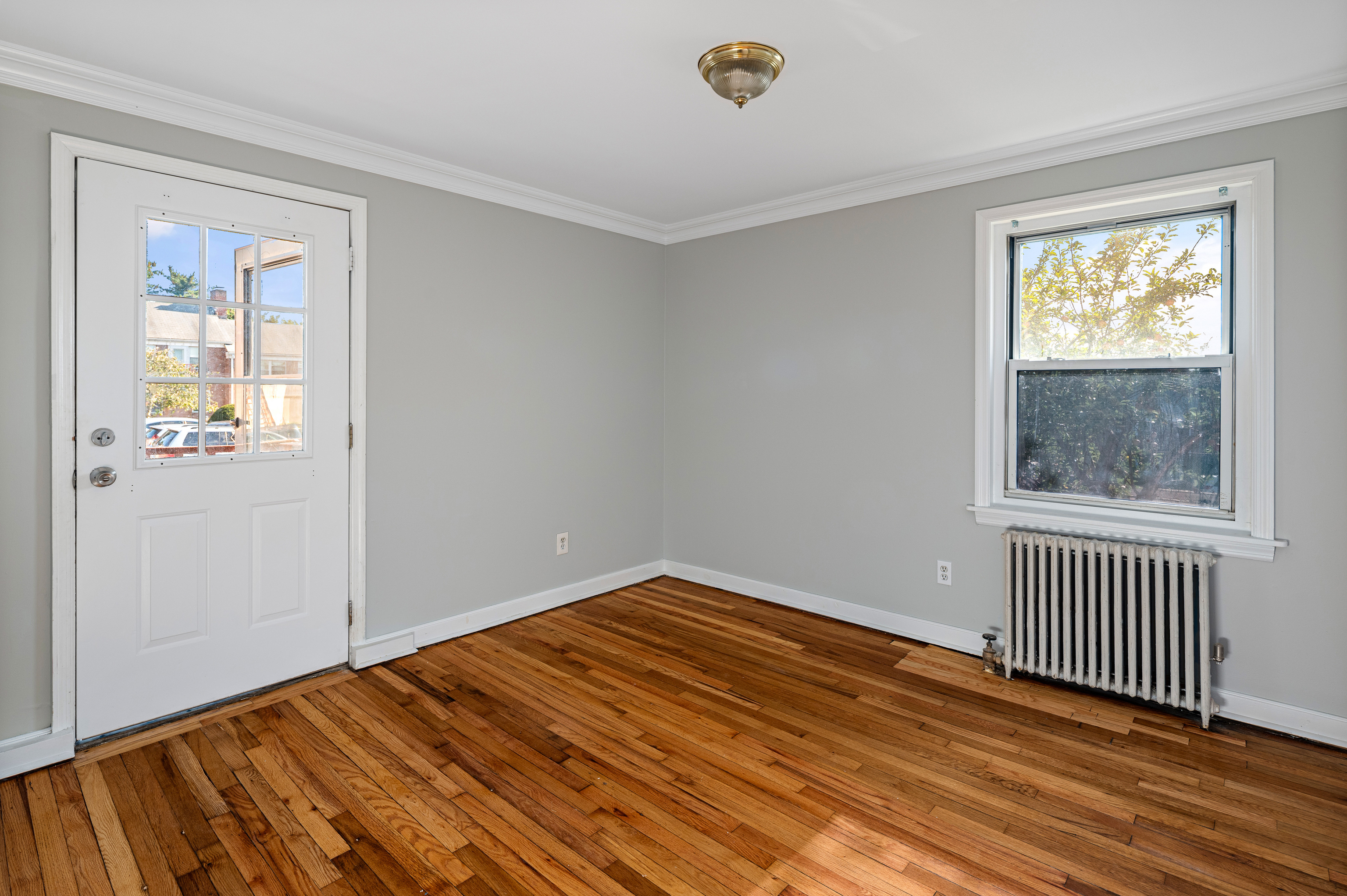 23 Standish Road, Unit 2 Stamford, CT 06902 - Photo 18 of 27 an empty room with wooden floor and windows