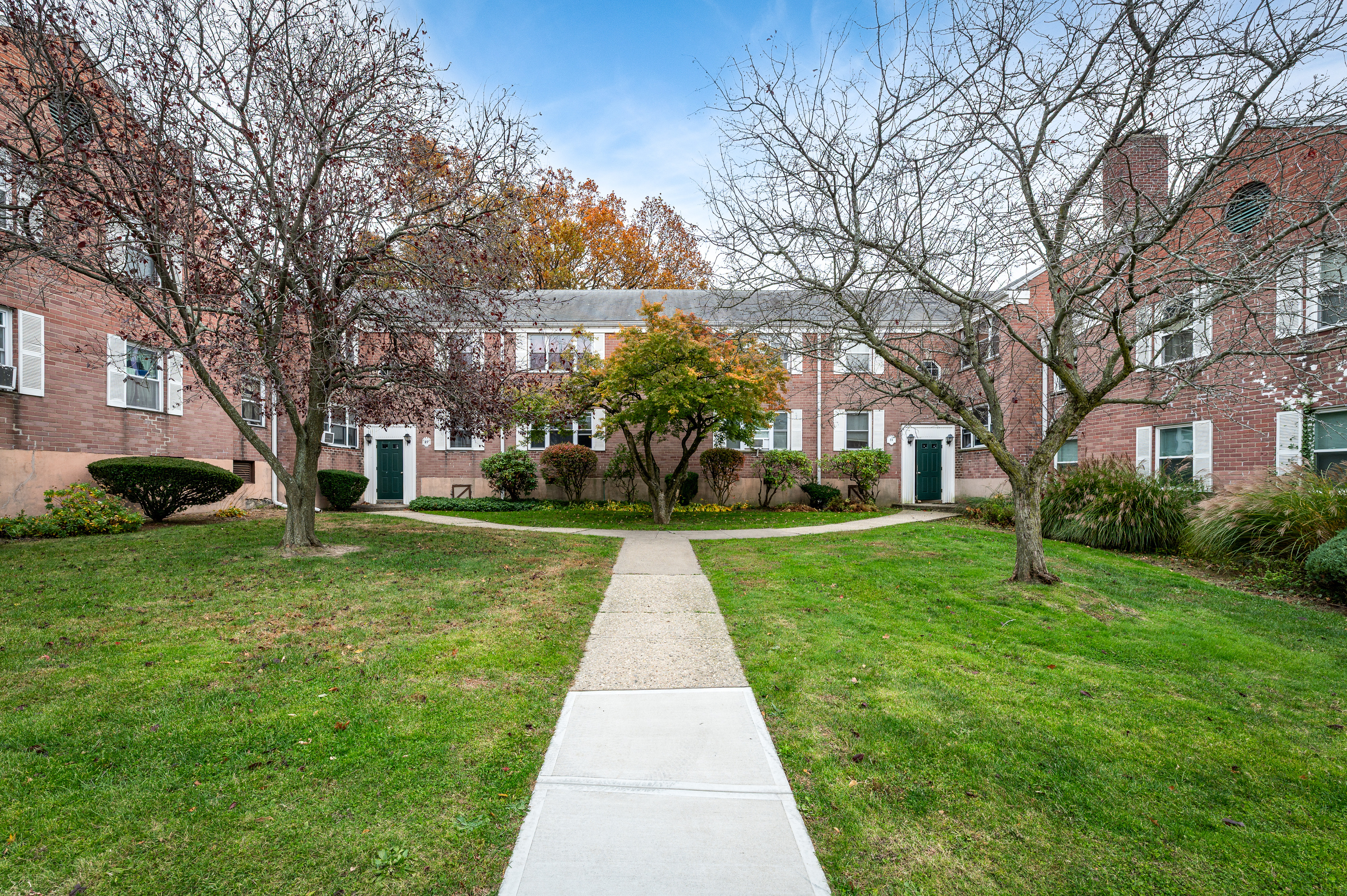 23 Standish Road, Unit 2 Stamford, CT 06902 - Photo 26 of 27 a view of a white house with a yard
