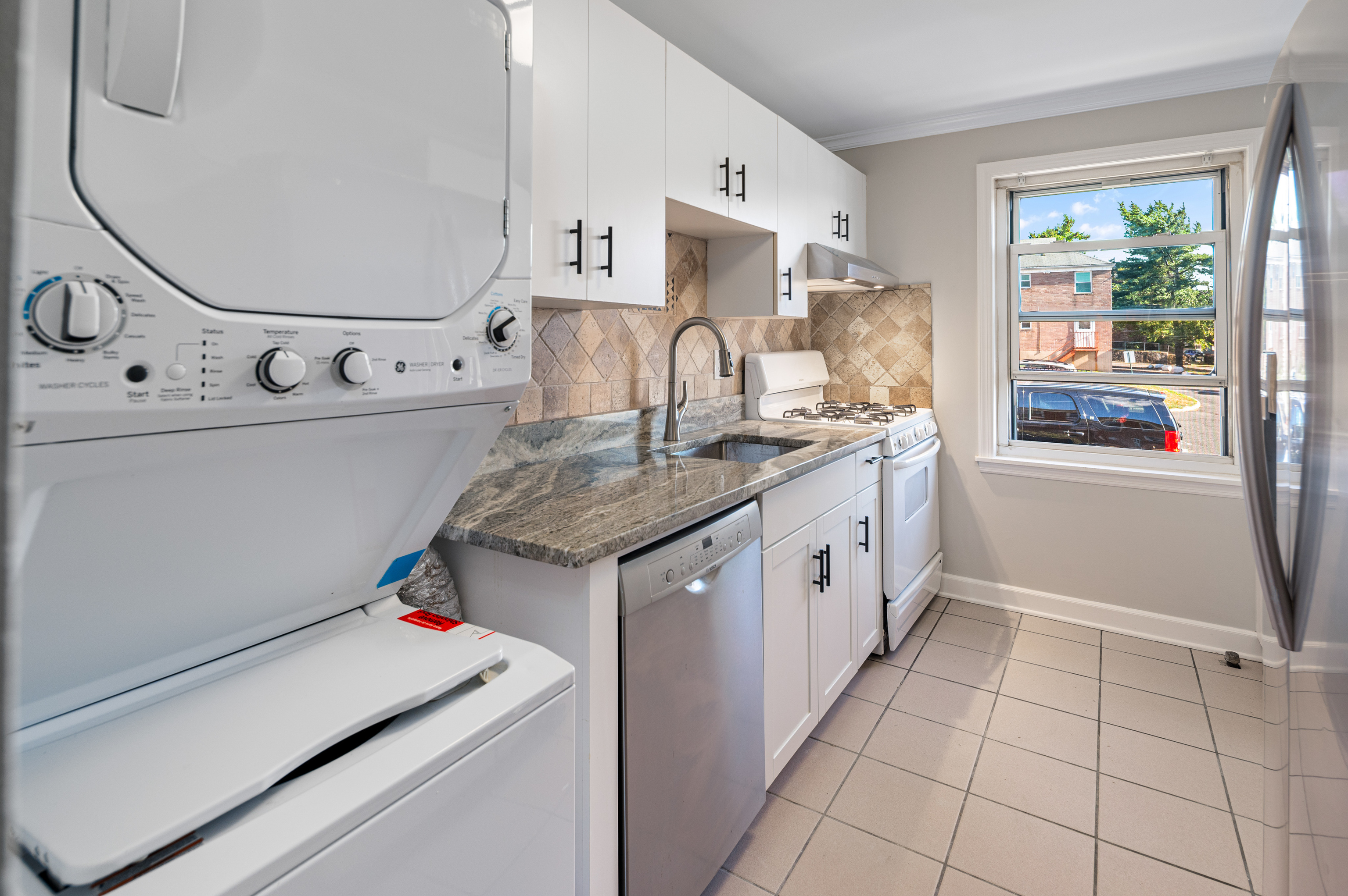 23 Standish Road, Unit 2 Stamford, CT 06902 - Photo 8 of 27 a utility room with cabinets washer and dryer