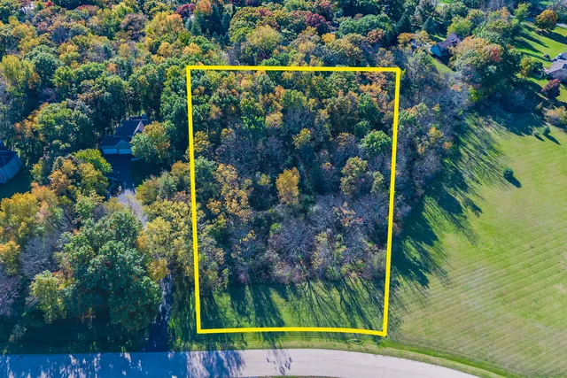 an aerial view of a houses with a lake view
